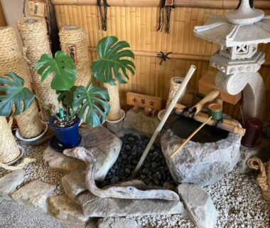 Bamboo water spout, stone basin, lantern and plants at Ryokan gastronomique Komakusa in Gifu