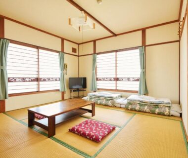 Tatami room with low table and folded futon at Ryokan Ogita near Shiraoi Station, Hokkaidō