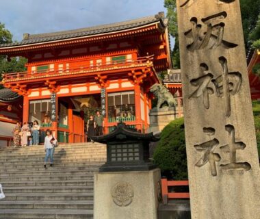 Shrine entrance with stone pillar, red gate and steps, near Mei Wa Inn in Kyoto