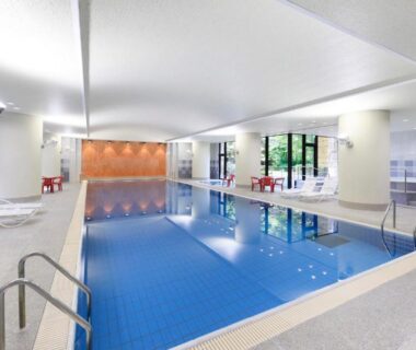 Indoor pool with seating and large windows at La Conte Arima, Arima Onsen, Hyōgo, Japan