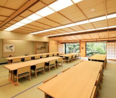 Long tatami dining hall with low tables, shoji screens and garden view at La Conte Arima, Hyogo, Kansai
