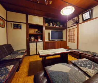 Japanese lounge with low table, floor cushions and sofas at Ryokan Kashiwaya in Nagano, Chūbu, Japan
