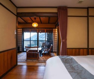 Bed and tatami seating area with shoji screens and balcony view, Kiri no Kaori Sakura, Shizuoka
