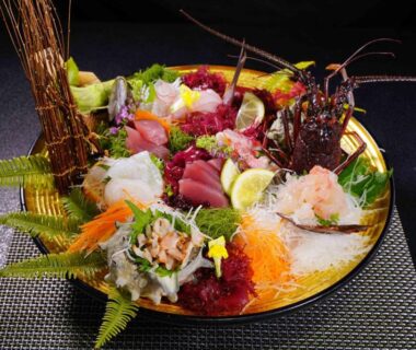 Assorted sashimi with lobster and seasonal seafood garnishes on a decorative platter at a Shizuoka ryokan