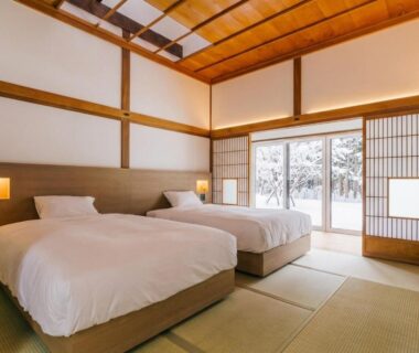 Two beds on tatami with shoji screens at 森のオーベルジュ 三 みつ in Hokkaidō
