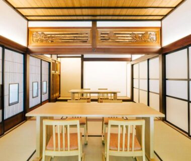 Traditional tatami dining room with low tables, chairs, shoji screens and carved transom at 森のオーベルジュ 三 みつ in Hokkaidō