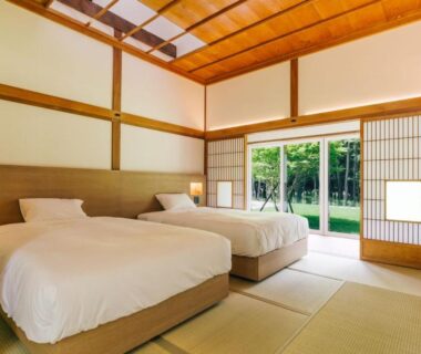 Tatami room with two beds, shoji screens and garden view at 森のオーベルジュ 三 みつ in Hokkaidō