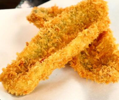 Golden breaded fried sticks on paper-lined plate at Minshuku Kazu in Chiba