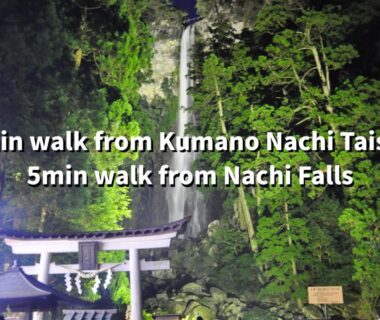 Illuminated Nachi waterfall with torii and forest, minutes from Mitaki Sanso in Wakayama's Kumano area