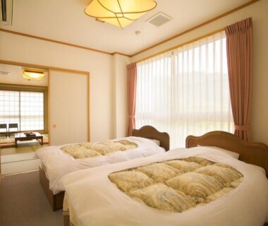 Bright twin bedroom with tatami room beyond at Ichinose, Shizuoka, Chūbu Japan