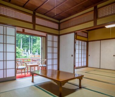 Tatami room with low wooden table and shoji doors at Marubun Dorogawa Onsen, Nara