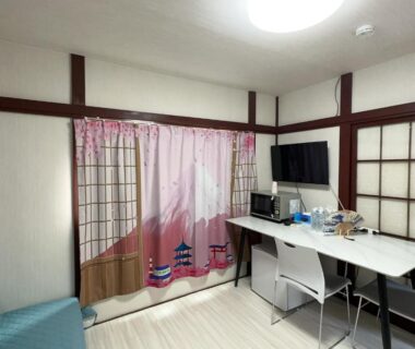 Compact room with shoji screens, desk, TV, sofa and Mount Fuji curtain at Futago no Yado in Asakusa Tokyo