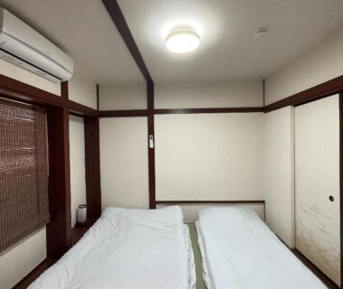 Two futons on tatami floor with sliding doors and bamboo blind at Futago no Yado Asakusa Tokyo