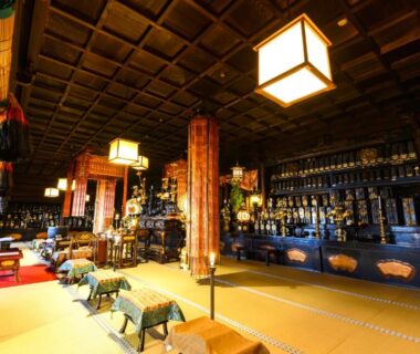 Interior tatami lounge with low tables, wooden pillars and bar counter at Shojo Shin-in Wakayama Kansai