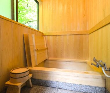 Indoor wooden soaking tub with wash area, stool and handheld shower at Shojo Shin-in, Wakayama