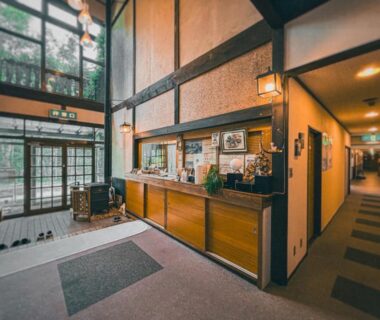 Entrance foyer with wooden reception desk at Sansō Watari, Nagano Chūbu