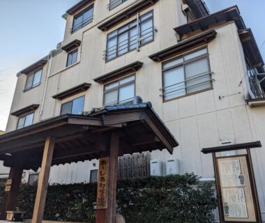 Multi story ryokan exterior with wooden entrance canopy, Onsenya Hirosuke, Fukushima Tōhoku