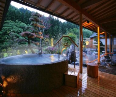 Wooden outdoor onsen baths with forested mountain backdrop at Yūsen Shidate, Iwate, Tōhoku
