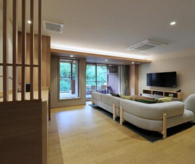 Spacious seating area with sofa, TV and garden view at Yūsen Shidate in Iwate, Tōhoku