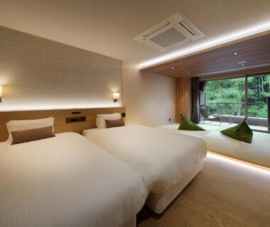 Twin beds with seating alcove overlooking garden at Yūsen Shidate in Iwate, Tōhoku, Japan