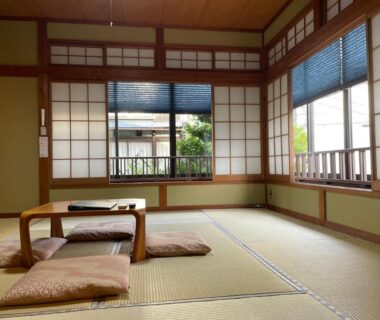 Tatami room with low table, cushions and shoji screens at Yuyado Sasakura in Hyōgo, Japan