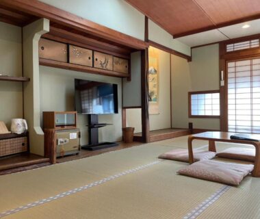 Tatami room with low table, shoji screens and television at Yuyado Sasakura, Hyōgo, Japan