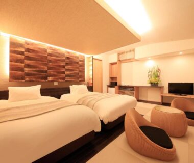Twin room with low lounge chairs and warm ambient lighting at 湯宿みゆきYuyado Miyuki, Gunma, Kantō