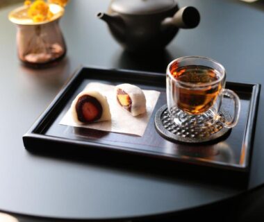Glass teacup and wagashi on a black lacquer tray at Oyado Kotobuki, Yumura Onsen, Hyōgo