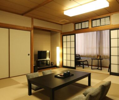 Tatami room with low table, cushions, and shoji screens at Oyado Kotobuki, Yumura Onsen, Hyōgo