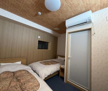 Two single beds, compact layout, air conditioner, frosted glass door at Auberge de poudreuse de Yuzawa, Niigata, Chūbu Japan