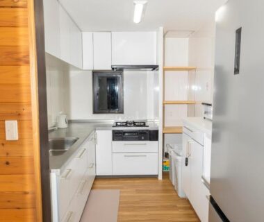 Small white kitchenette with gas stove and refrigerator at Yune no Sakura, Gunma, Kantō, Japan