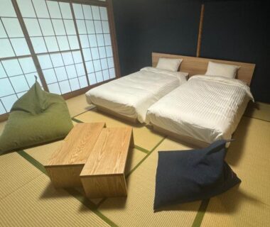 Twin beds on tatami with shoji screens and low table at 源泉掛け流しの宿Albergo湳 Kanagawa Japan