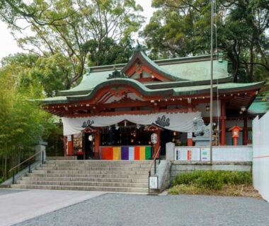 Kinomiya shrine building with green copper roof, stone steps and trees at Atami, Shizuoka
