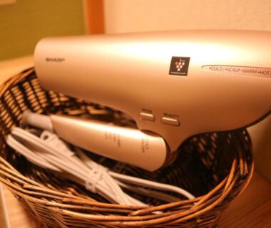 Hair dryer and wicker basket on bathroom counter at Ryokan Hōetsu in Atami, Shizuoka