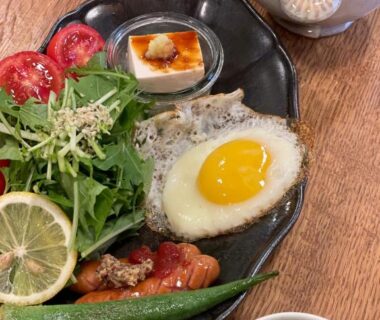 Sunny-side egg with salad, tofu, okra and watermelon served on wooden table at ryokan 玄か~sizuka~ Kyoto