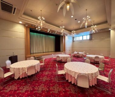 Round banquet tables, stage, chandeliers at Keyaki no Yado, Yamagata