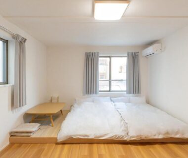 Futon on wooden floor with low table, bright minimalist room at Mizu no Yado Asakusa, Tokyo