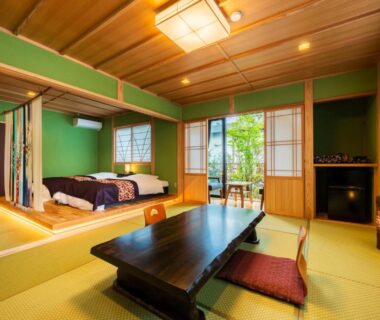 Traditional tatami room with low table, futon bedding and shoji screens at Ryoso Makibanoie in Ōita