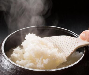 Hand scooping steaming rice from a pot at Koemon auberge apaisante, Hyōgo, Kansai Japan