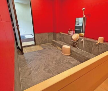 Indoor stone bath with wooden stools and shower fixtures, Kiimiso ryokan, Wakayama, Kansai