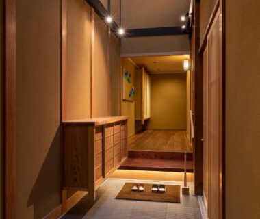 Genkan entrance with wooden shoe cabinet, slippers on tiled floor and raised wooden corridor at Kyōka auberge de Gion, Kyoto