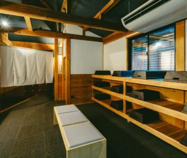 Wooden changing area with benches and cubbies at Kamikura Matsurube Onsen in Iwate