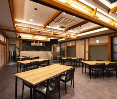 Spacious wooden dining hall with tables and shoji screens at Kamikura Matsurube Onsen in Iwate, Tōhoku