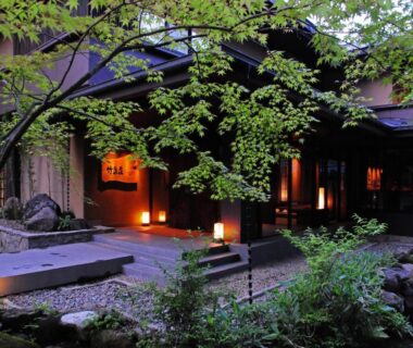 Evening entrance with lanterns, stone steps and green foliage at Chikusenso Onsen, Miyagi, Tōhoku