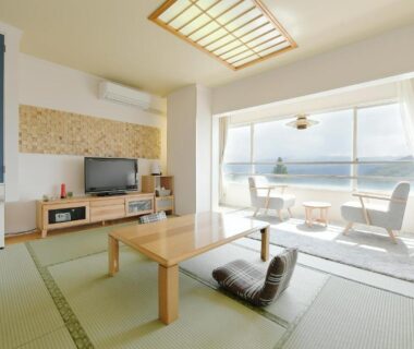 Bright tatami room with low table and balcony overlooking lake at 箱根芦ノ湖 HOTEL RaKuun Kanagawa Japan