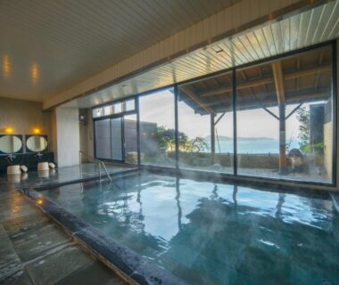 Large indoor onsen overlooking coastal waters at Shinpachiya ryokan in Mie, Kansai