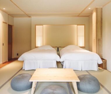 Tatami room with twin beds, low table and floor cushions at 蓼科BASE kitchen,spa&hotel in Nagano
