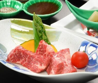 Sliced marbled beef with asparagus and cherry tomato on decorative ceramic plate at Kinosato, Zaō Onsen, Yamagata