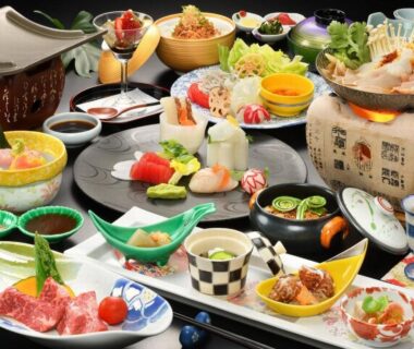 Assorted traditional multi-course Japanese meal with sashimi grilled items and side dishes at Kinosato Ryokan in Yamagata