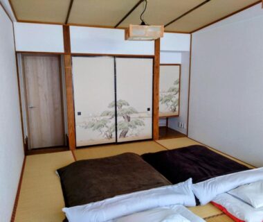 Tatami room with futon bedding and painted fusuma doors, Ringoya ryokan, Zaō Onsen, Yamagata, Tōhoku, Japan